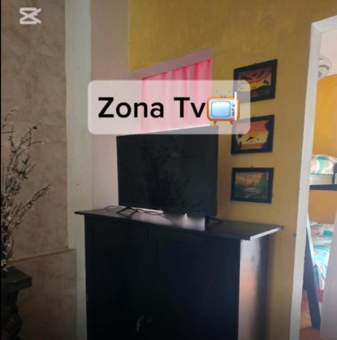 a television on a stand in a room at Casa de Descanso la Cascada in Sopetrán