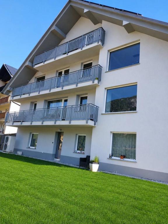 an apartment building with balconies and a lawn at Sofija 1 in Jesenice