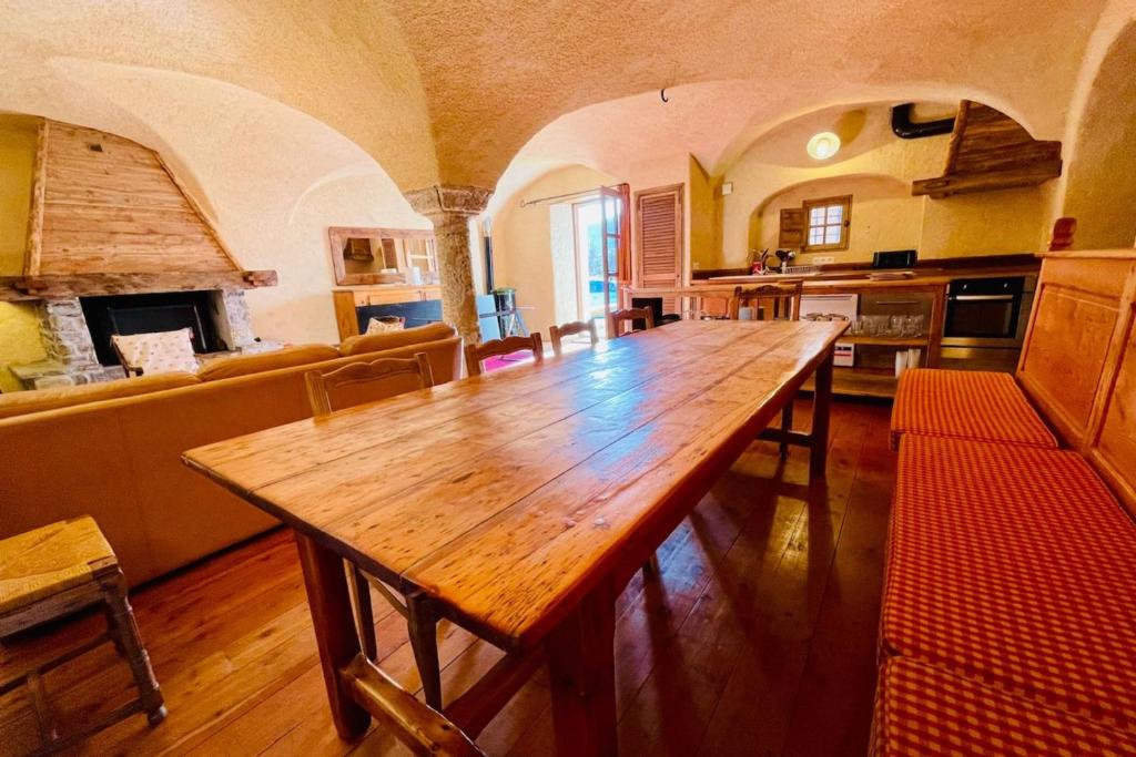 a large kitchen with a wooden table in a room at 130 sqm Apartment in a Village House in La Salle-les-Alpes