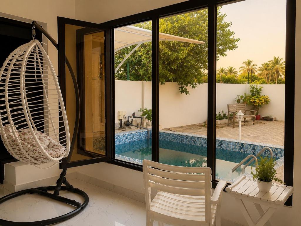 a room with a view of a pool through a window at Al Rabi Rest House in Khor Fakkan