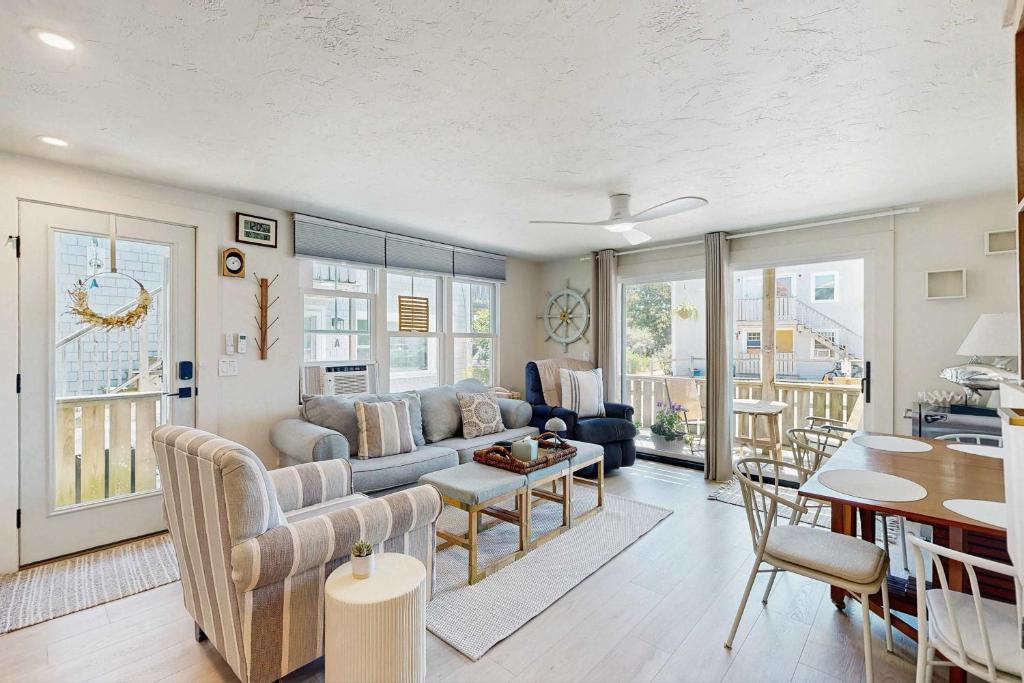 a living room with a couch and a table at Moon Tide - Bayside Beach Access & Parking in Provincetown