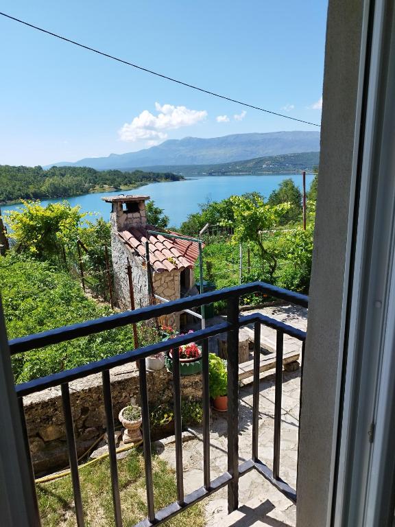 a view of a lake from a balcony at Mara village house in Vrlika