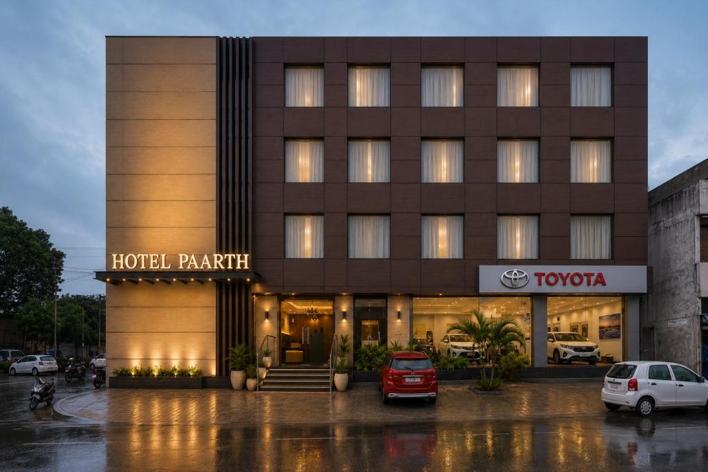 a hotel parking lot in front of a building at Hotel Paarth in Ludhiana