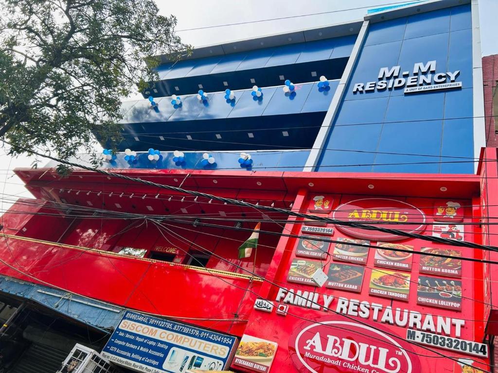 a red bus with signs on the side of it at m m residency in New Delhi