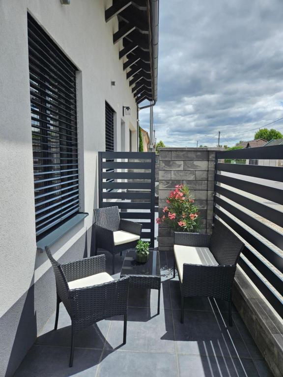 a patio with chairs and a table on a balcony at Penzión ANTRACIT in Štúrovo