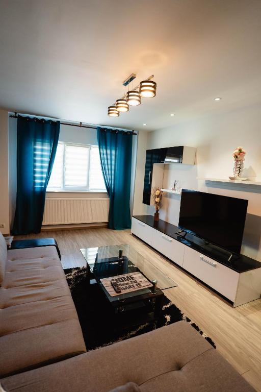 a living room with a couch and a table at Danube Breeze Apartment in Giurgiu