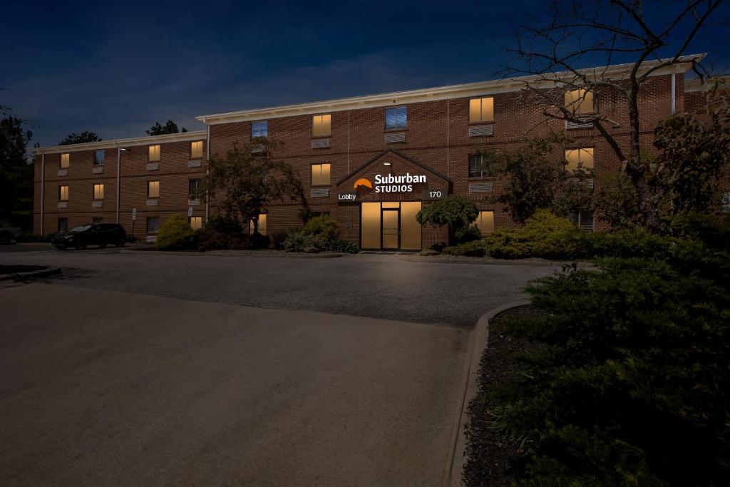 a building with a sign on the front of it at Suburban Studios Copley Akron West in Copley