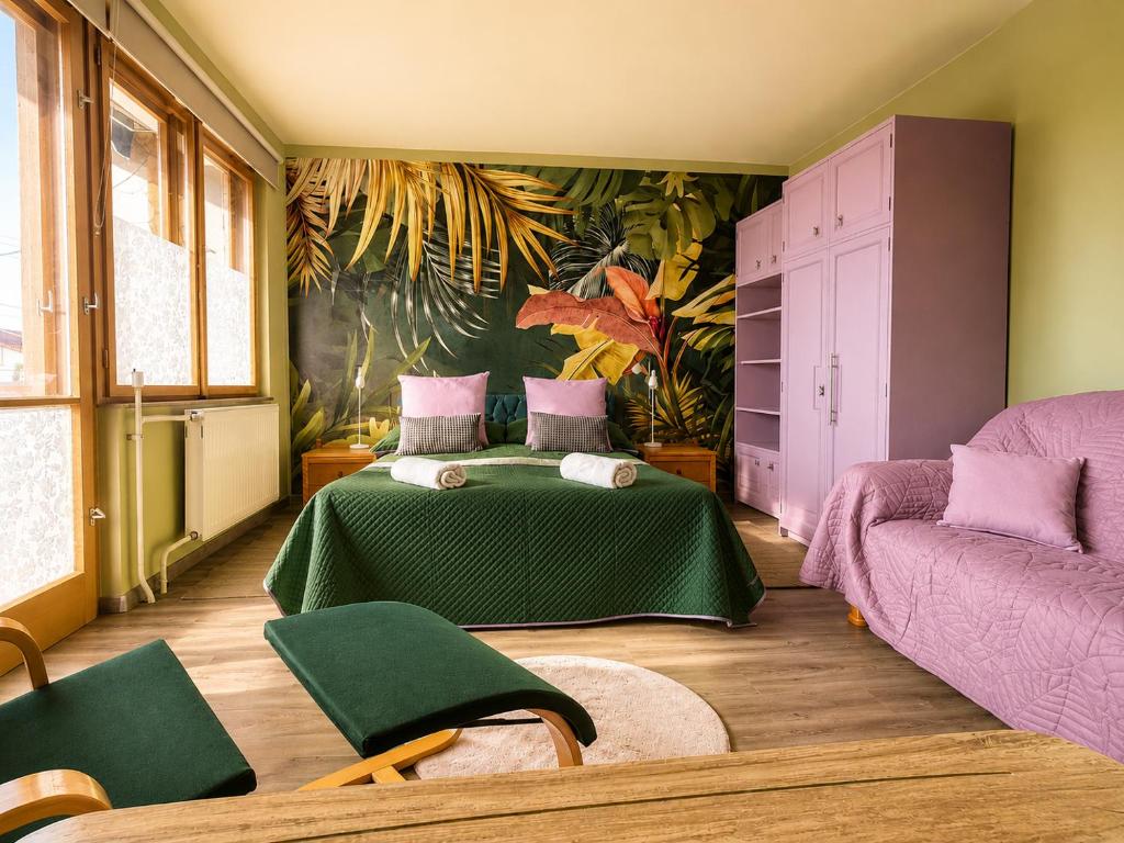 a bedroom with a bed and a couch at Sefira Homes G in Keszthely
