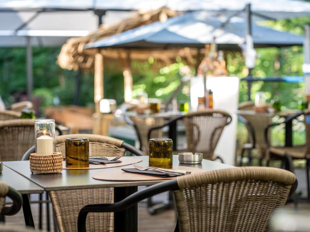 an outdoor table with two glasses of beer on it at Novotel Valence Sud in Valence