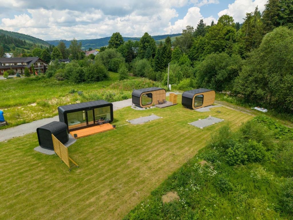 an overhead view of three camping cottages on a grass field at Tatry Panorama House in Zuberec