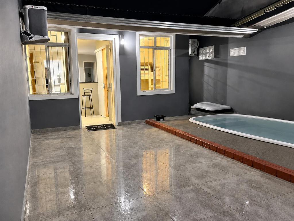 a large bathroom with a tub in a room at House Pontal do Paraná in Pontal do Paraná