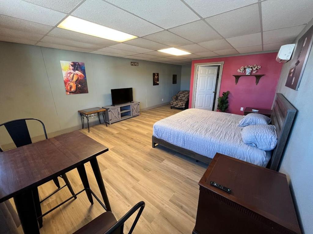 a bedroom with a bed and a table and a dining room at Athens House number 7A in Las Vegas