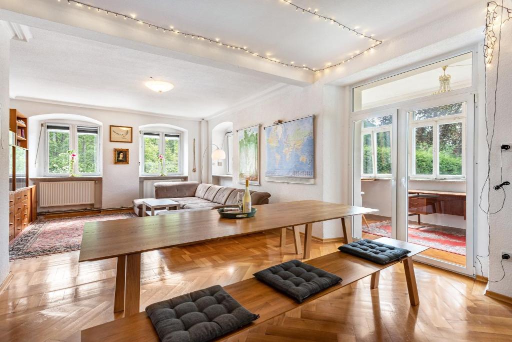 a living room with a table and a couch at Apartment In A Historic Villa in Stockach
