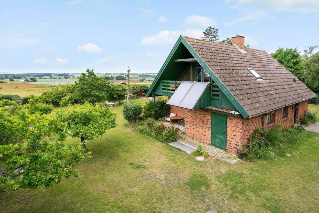 a small brick house with a green roof at 4044-Borre-Klintholm-Havnevej-40 in Borre