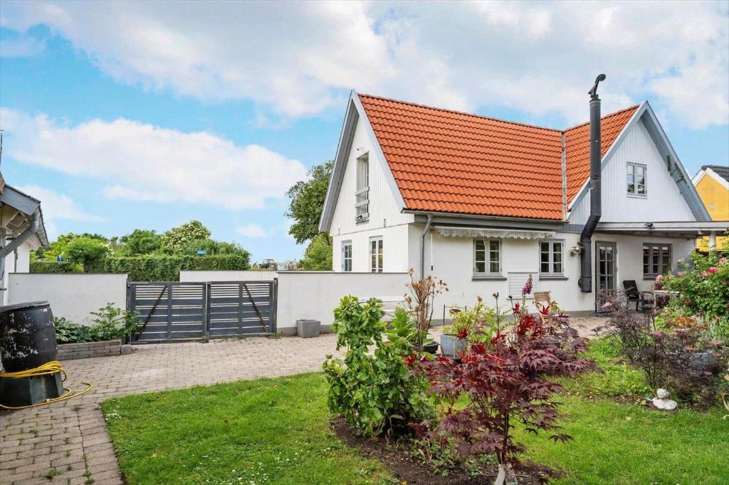 a white house with an orange roof at 6010-Askeby-Fanefjordgade-71 in Askeby