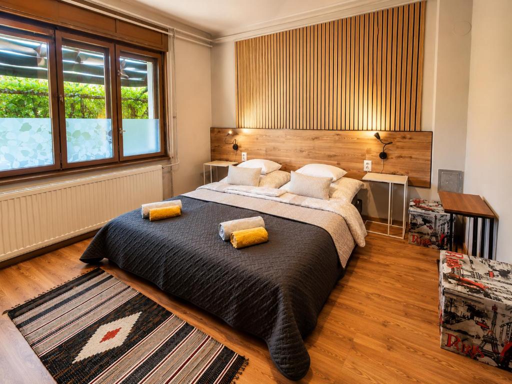 a bedroom with a large bed and a large window at Sefira Homes Y in Keszthely