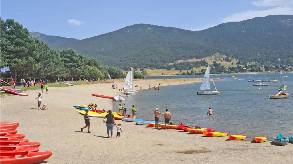 a group of people on a beach with boats at Centre village, proche toutes commodités in Les Angles