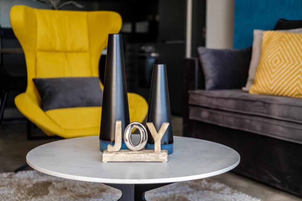 a table with a joy sign on it in a living room at Kay-Stay in Larnaca