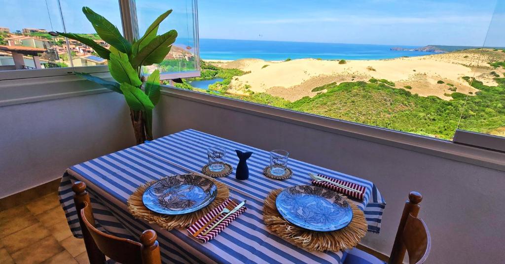 a blue and white table with a view of the beach at Golden Dune View in Torre Dei Corsari