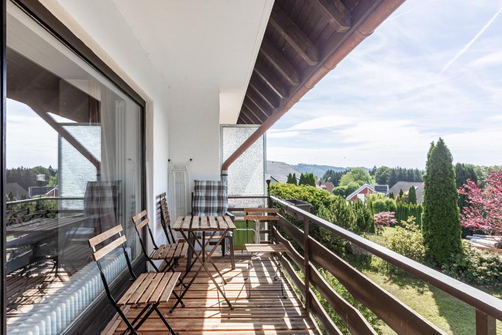 a balcony with a table and chairs and a view at Beautiful Apartment in Häusern