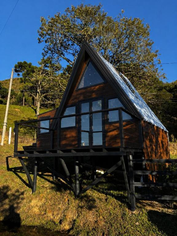 a tiny house sitting on a table in a field at Vale do Sossego- Cabana na Serra in Alfredo Wagner