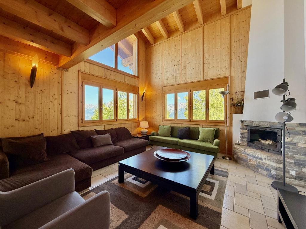 a living room with a couch and a table at Tschoueilles 009 MOUNTAIN & VIEW - chalet 12 pers in Veysonnaz