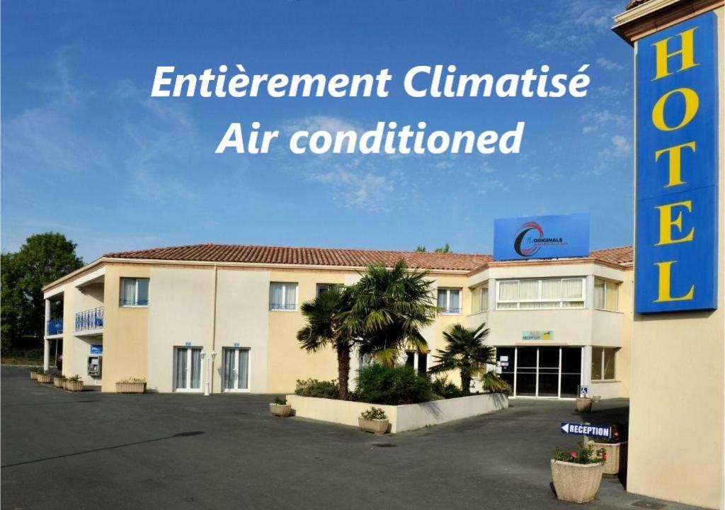 an apartment building with a sign that reads entertainment clinic air conditioned at The Originals City, Hôtel des Arènes, Saintes in Saintes