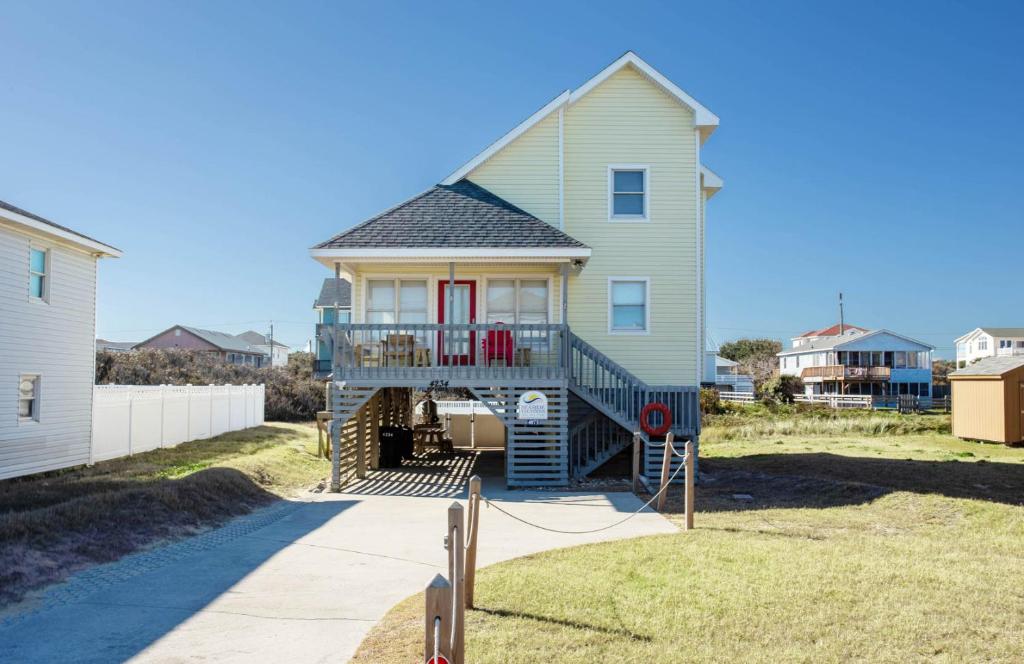 a house with a staircase leading up to a house at 4073 - Downtime in Kitty Hawk