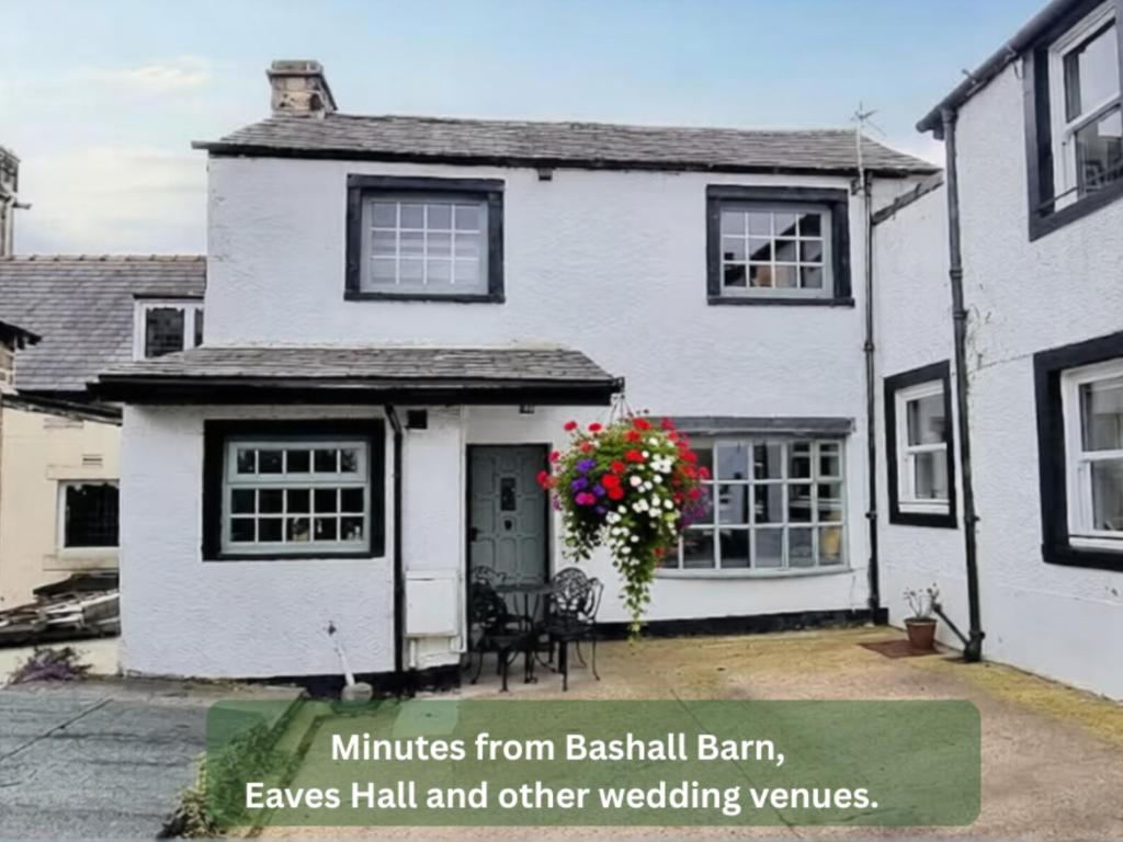 a white house with a wreath of flowers on the door at Bowland Breaks - Cobble View Cottage Cosy Retreat, Parking, Near Wedding Venues, Village Location with 3 great pubs in Waddington