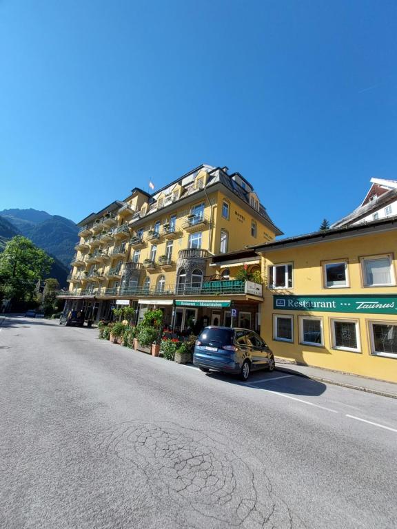 a car parked in front of a building on a street at Kurhotel & Hotel Mozart in Bad Gastein