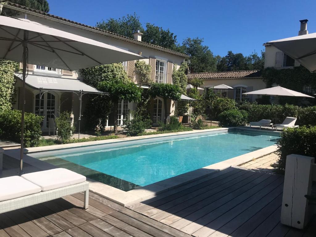 a swimming pool in the backyard of a house at Villa La Begude - Boutique B&B in Saint-Tropez