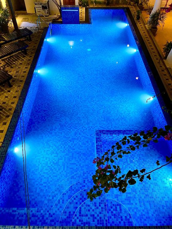 a large swimming pool with blue lights on it at Oasis Bay - Arugam Bay in Arugam Bay