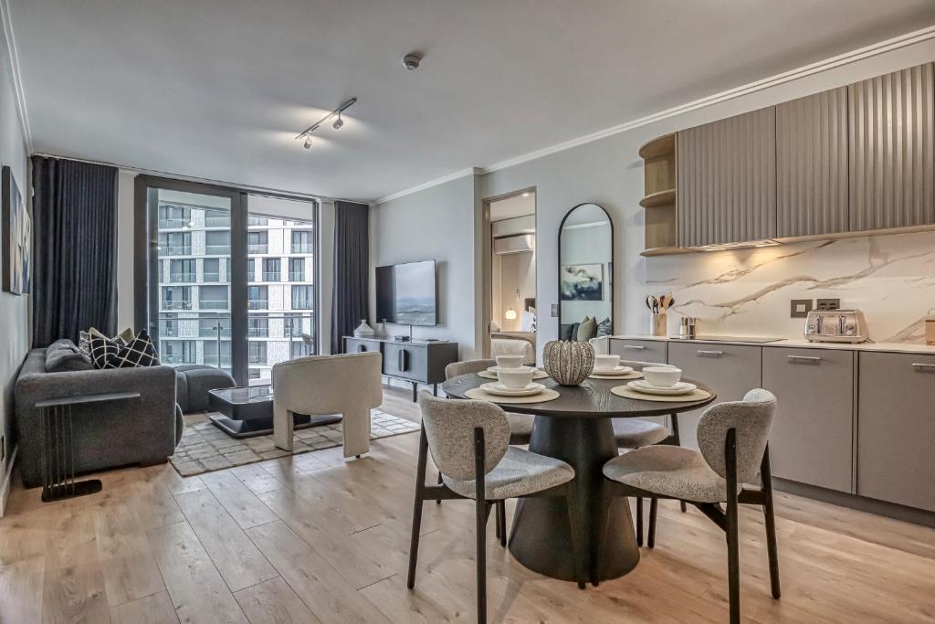 a kitchen and living room with a table and chairs at Stormside at Ellipse in Midrand