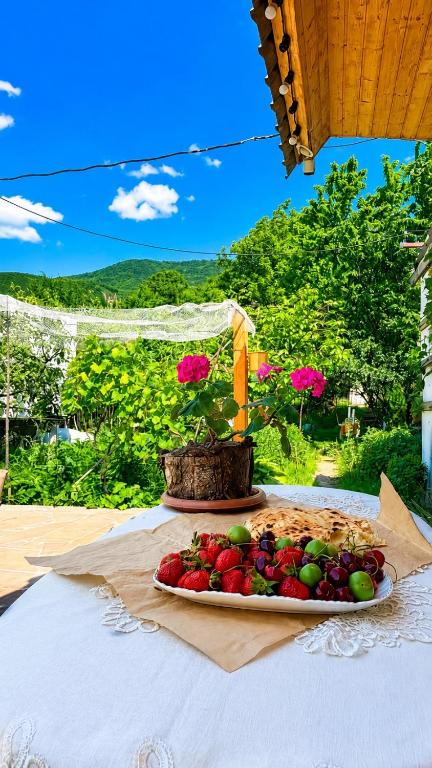 a plate of fruit sitting on a table at The Secret Garden House in Ijevan