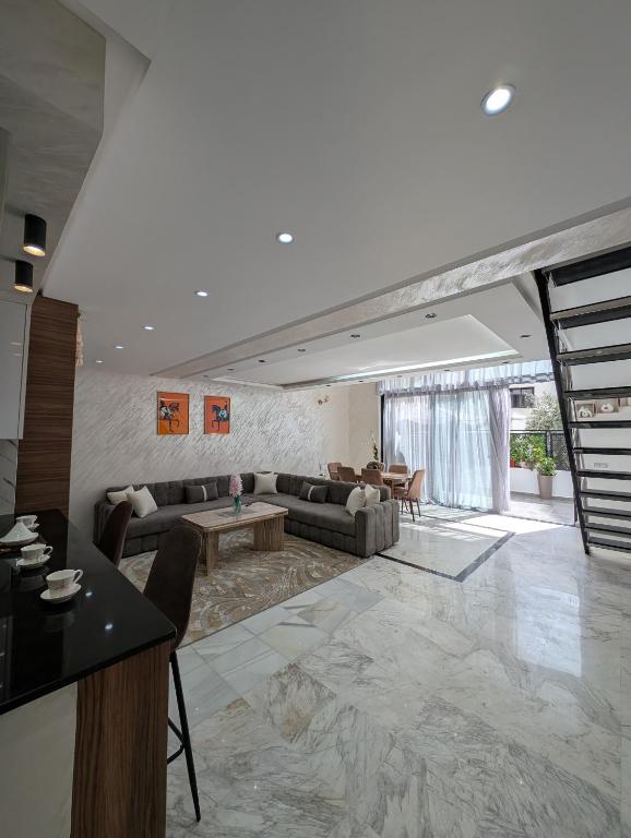 a living room with couches and a table at Tanger City 6 in Tangier