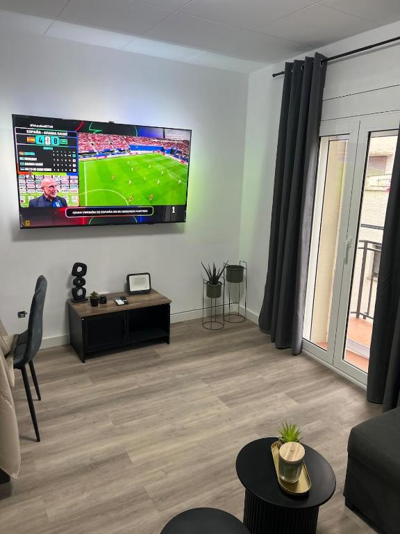 a living room with a flat screen tv on the wall at Apartment in Amer in Amer