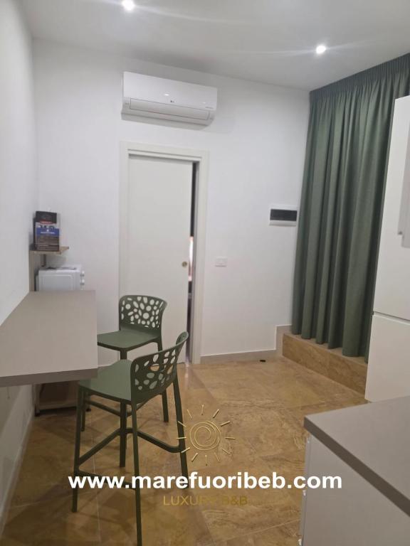 a room with a table and a chair in a room at MARE FUORI LUXURY B&b in Cassano delle Murge