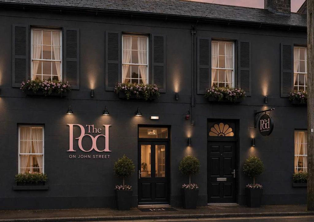 a black building with a sign that reads the road on main street at The Pod on John St in Wexford