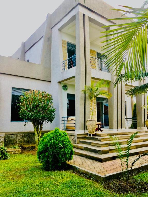 a large house with stairs in front of it at Gravity Villa Musanze in Ruhengeri
