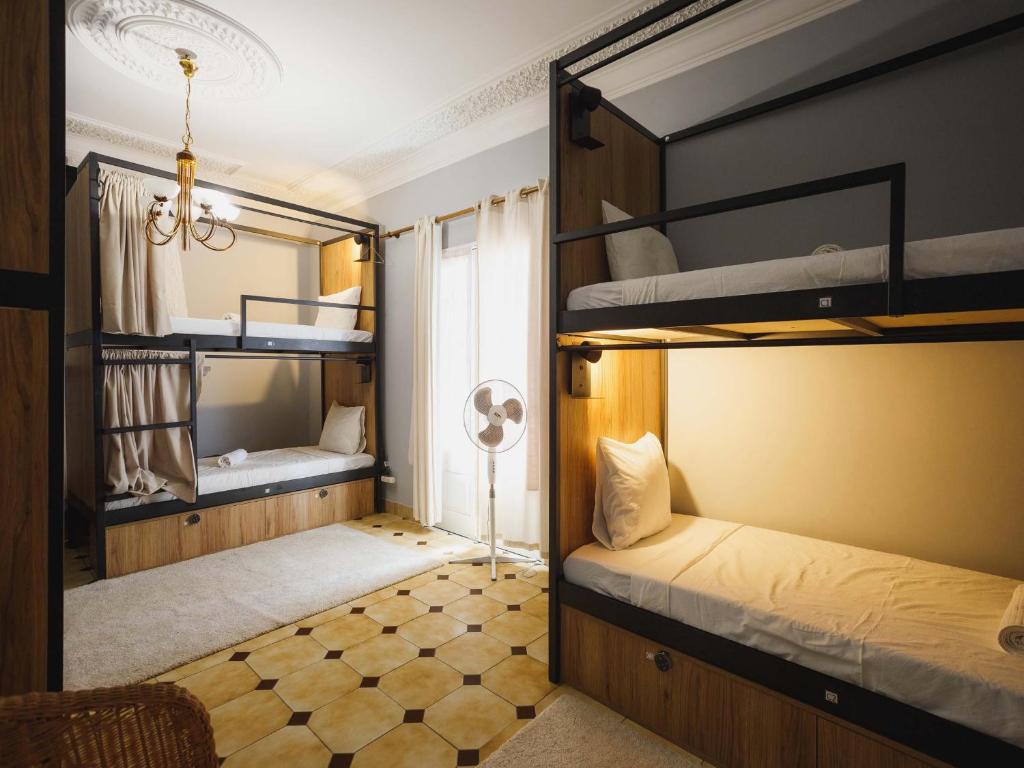 a room with two bunk beds and a fan at Akisol Hostel Idanha in Idanha-a-Nova