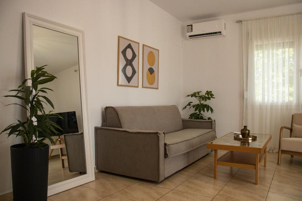 a living room with a couch and a table at Diame Suite - Tzivelekidou in Chrysoupolis