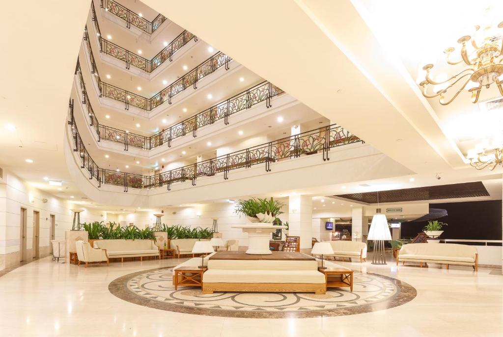 a lobby of a hotel with furniture and a chandelier at Palasia Hotel in Koror