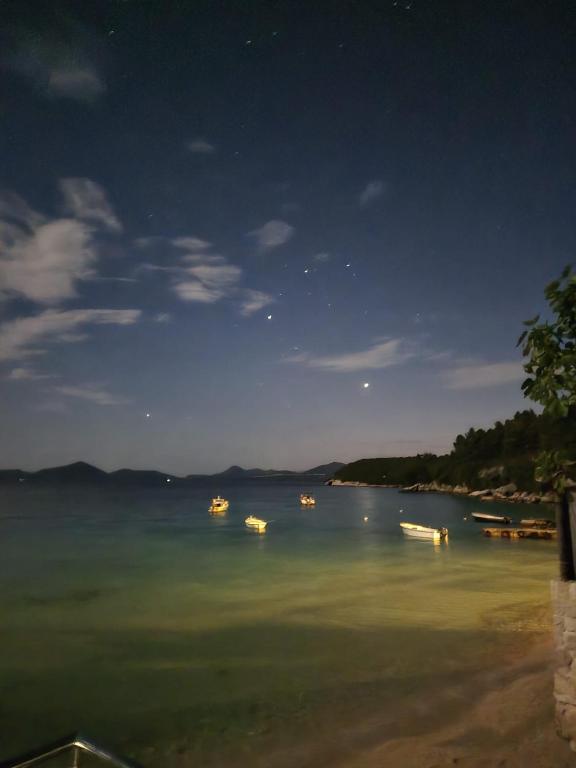 a group of boats in the water at night at Moreto in Slano
