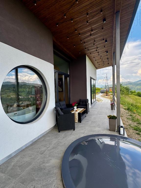 a house with a round window on a patio at Vershok villa in Slavske