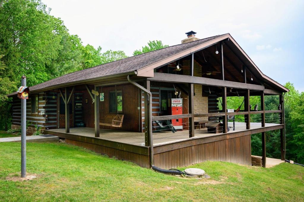 a large wooden cabin with a large deck at Moonlight Ridge in Laurelville