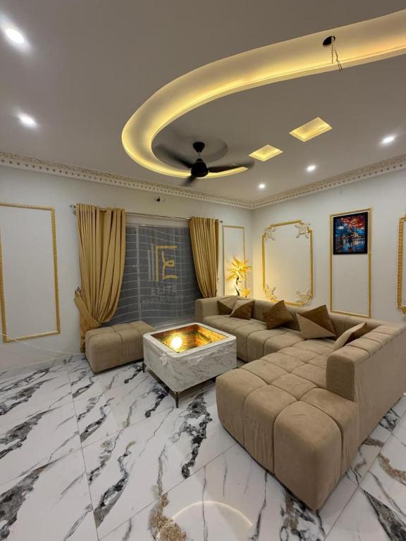 a living room with a couch and a fire place at Elite Enclave inn in Islamabad