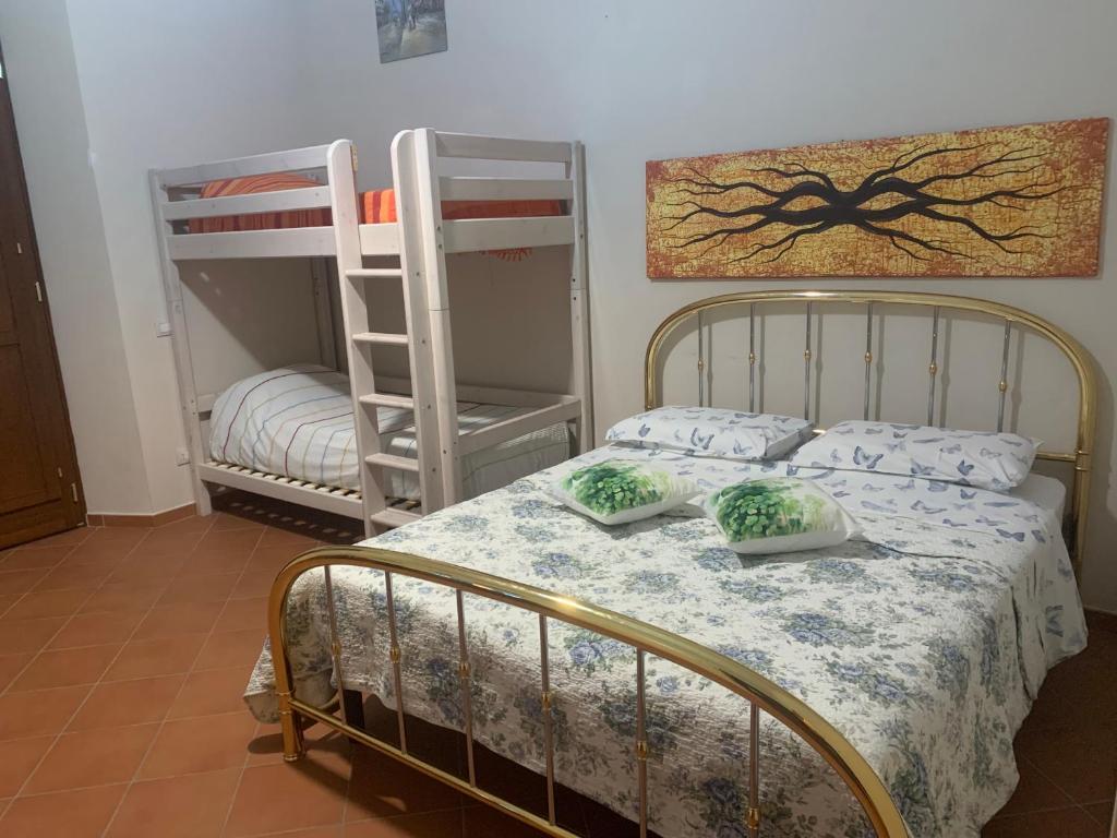 a bedroom with a bed with two bunk beds at Il Quadrifoglio Nascosto in Pontassieve
