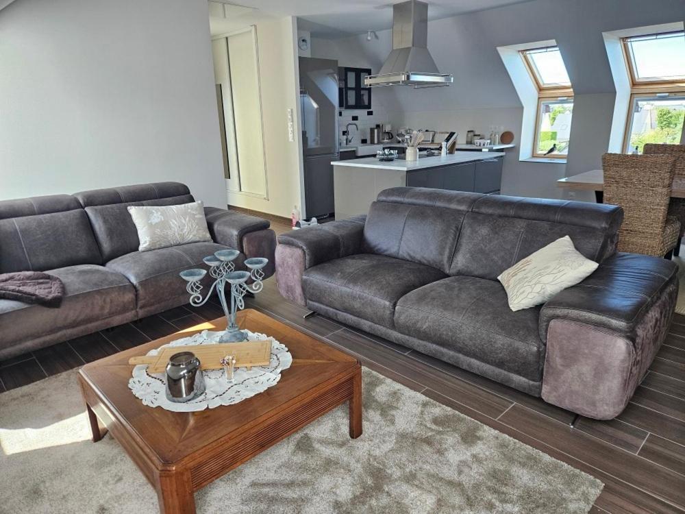 a living room with a couch and a coffee table at Cap à l'ouest in Saint-Benoît-des-Ondes