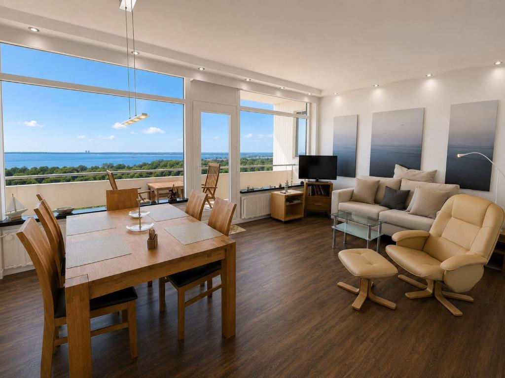 a living room with a couch and a table and chairs at Panoramic App B10-7 in Sierksdorf