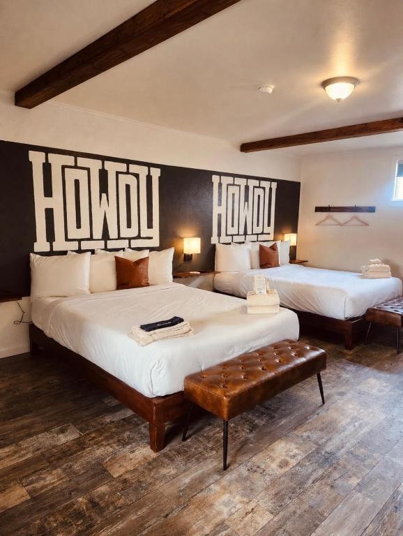 two beds in a room with two large beds at Elk Antler Inn in Thermopolis
